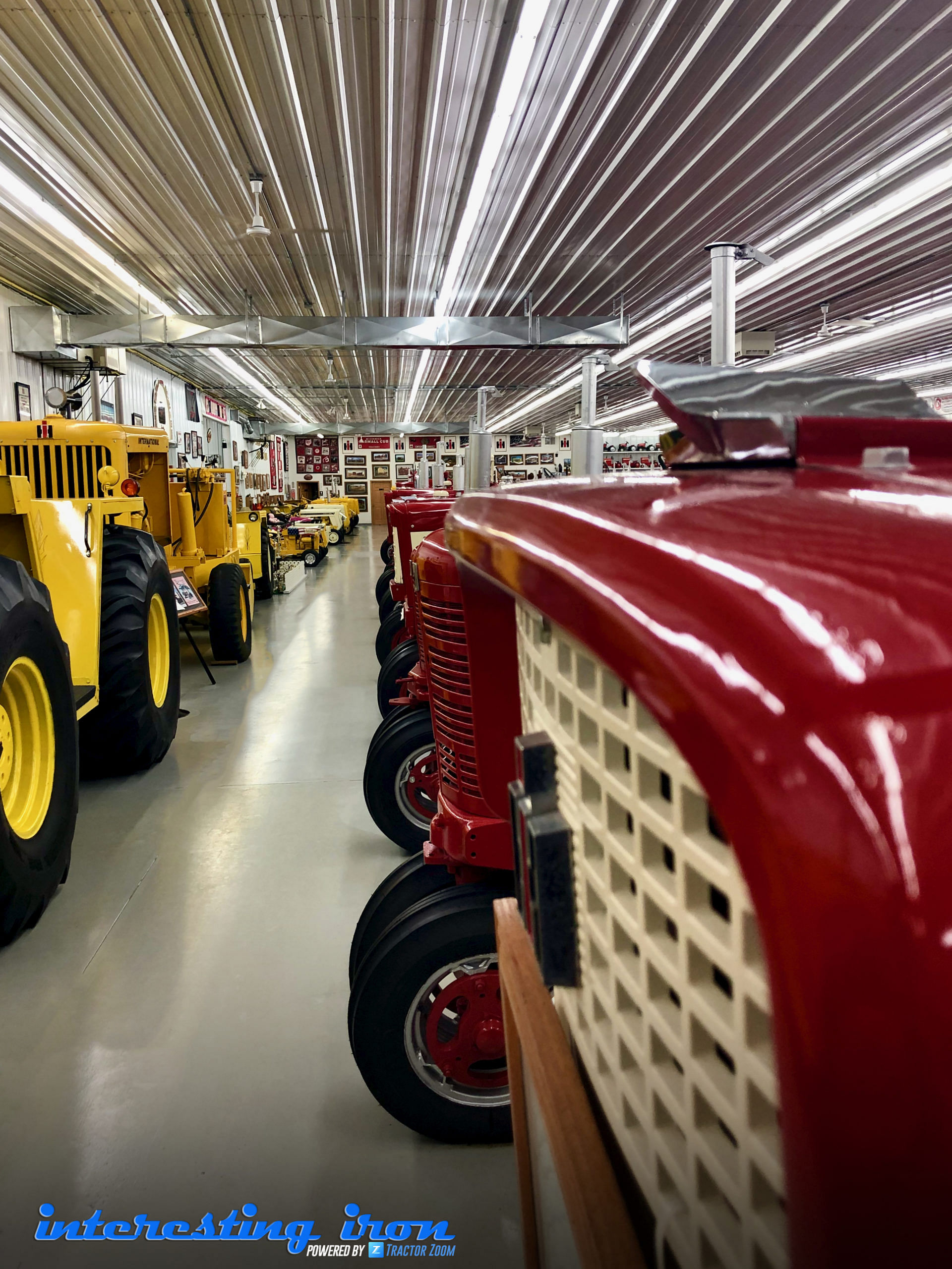 a row of red tractors and a row of yellow tractors