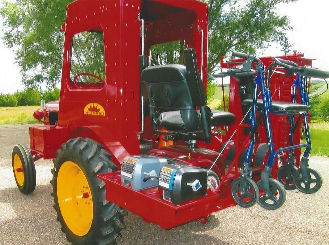 red empire tractor at auction with a handicapped-accessible ramp on the operator's platform