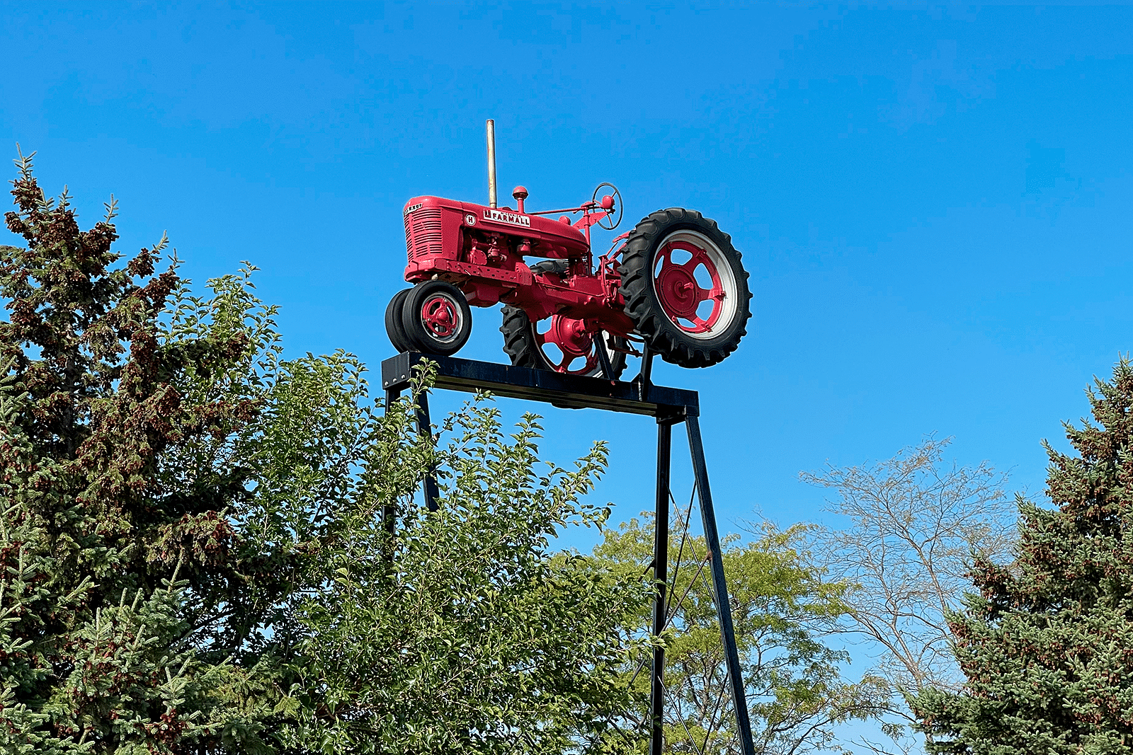 Farmall H on the top of a tall tower, welcoming guests to Farmall Land.
