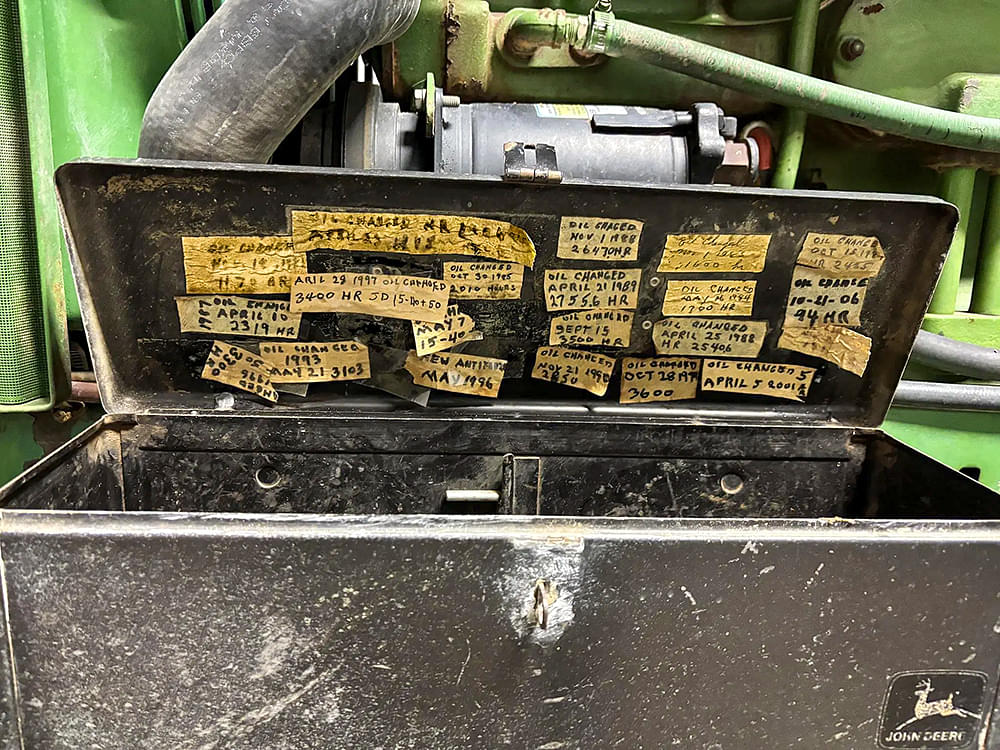 John Deere 4430 toolbox with oil changes written out on masking tape.